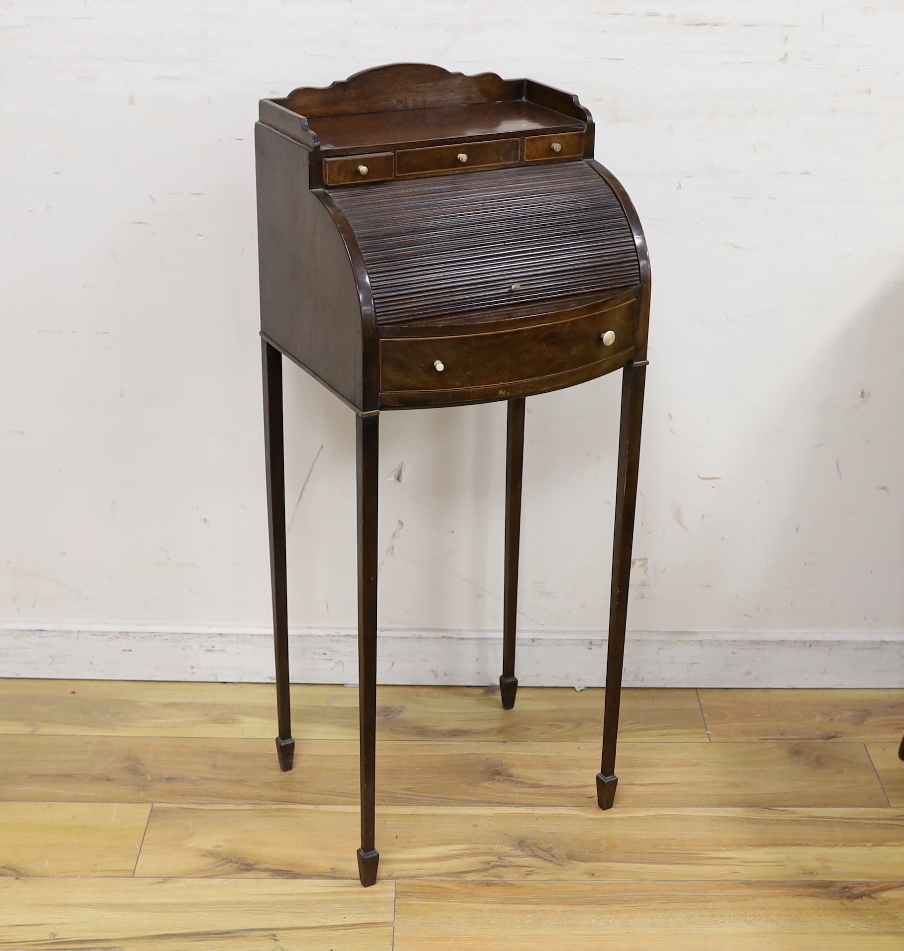A small Edwardian mahogany Sheraton Revival bowfront tambour desk, width 38cm, depth 35cm, height 95cm
